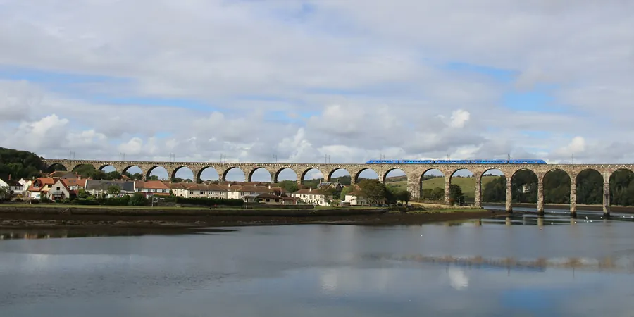 A train crossing the arches of the Royal Border Bridge over the River Tweed