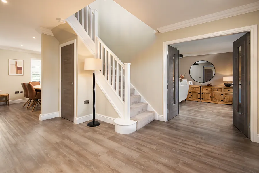 Bright hallway with a white staircase
